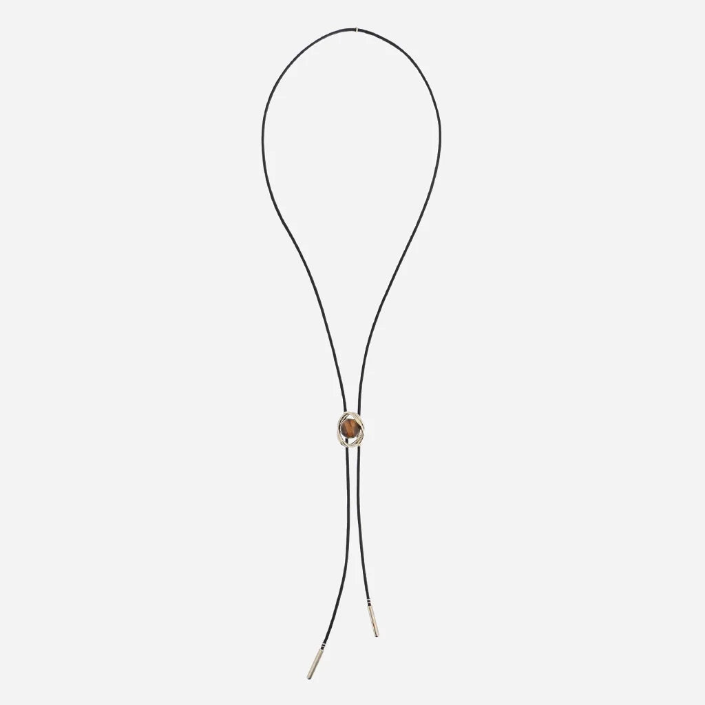 Collier cravate Bolo Anomalie unisexe en cuir noir, avec détail en satin doré et perle naturelle œil de tigre.