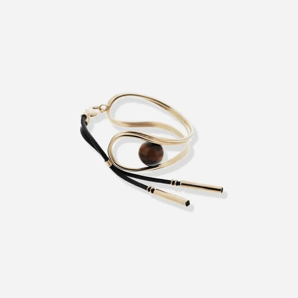 Bracelet perle Anomalie graphique pour femme en métal doré, cuir noir et perle œil de tigre.